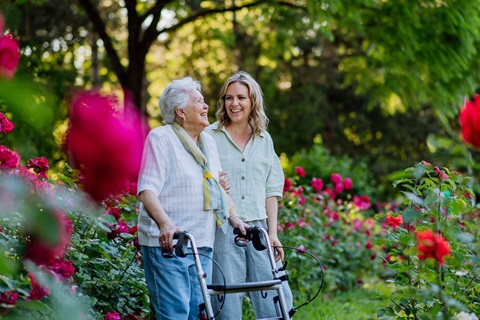 Older lady walking with carer