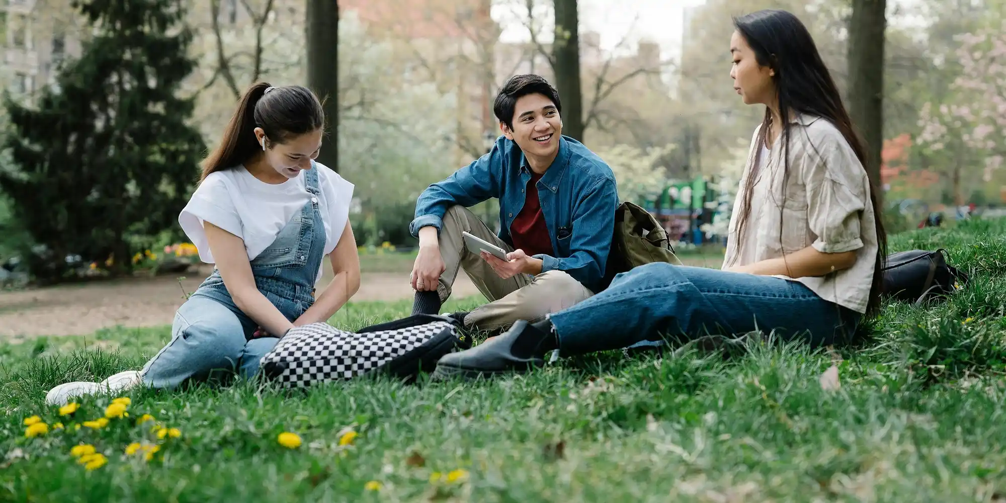 3 youth sitting in the bush