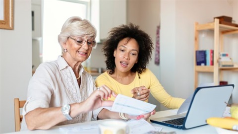 2 people looking at invoices