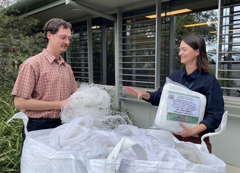 2 people exchanging illegal fruit nets for legal fruit nets