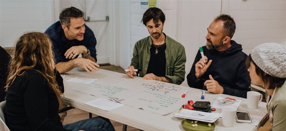 People gathered at a workshop table