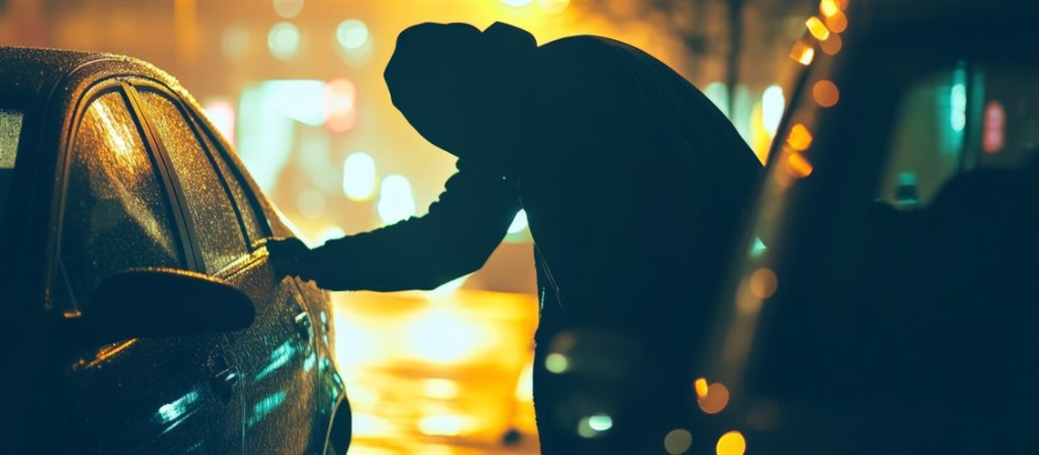 Person trying to break open a car